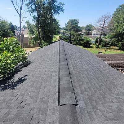Top view of a residential roof with new gray shingles installed by Lira Roofing